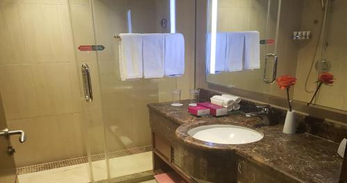 a bathroom with a sink and a shower at Crowne Plaza Madinah by IHG in Al Madinah