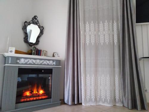 a fireplace in a living room with a curtain at B&B Regina Margherita in LʼAquila