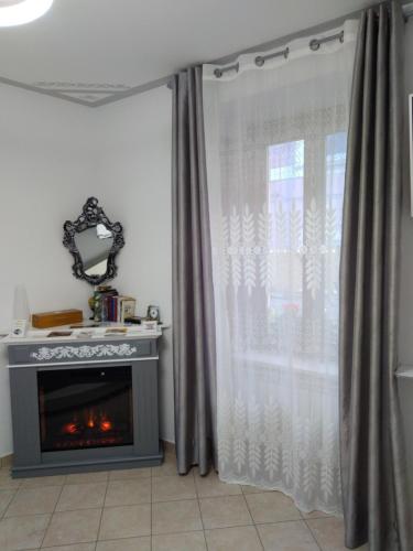 a living room with a fireplace and a curtain at B&B Regina Margherita in LʼAquila