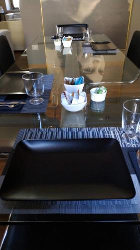 a glass table with bowls and plates on top of it at B&B La Dimora Della Zarina in Mormanno