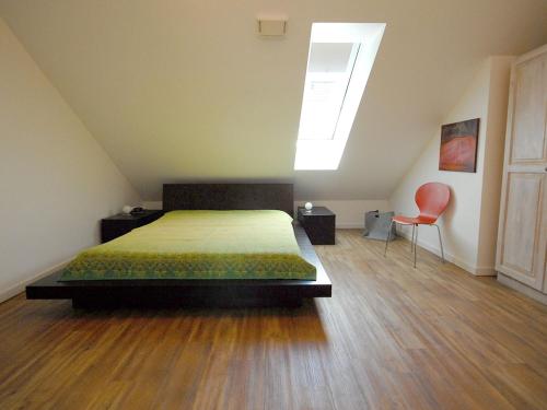 a bedroom with a bed and a skylight at Ruhepol in Travemünde