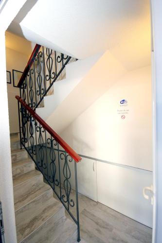 a staircase in a house with a red railing at Apartments Kojic in Bar