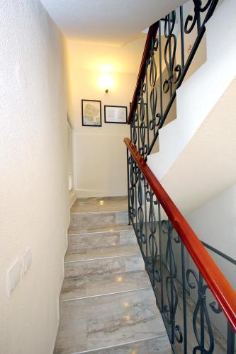 a staircase in a house with a red railing at Apartments Kojic in Bar