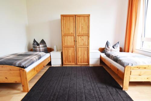 a bedroom with two beds and a window at Work and Stay Apartment Cologne- Fühlinger See in Chorweiler