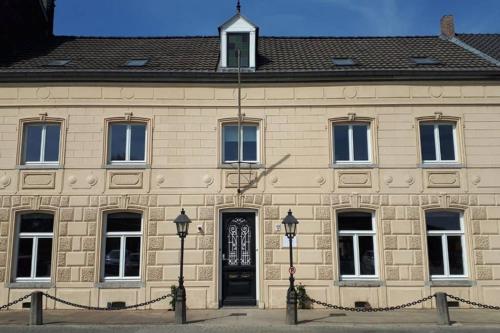 a large stone building with a black door at Authentic Stays - 6p-maisonette in Eijsden