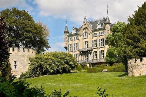 a large castle with a grassy field in front of it at Authentic Stays - 6p-maisonette in Eijsden