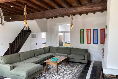 a living room with a couch and a table at Authentic Stays - 6p-maisonette in Eijsden