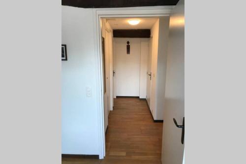 a hallway with white walls and wooden floors at Authentic Stays - 6p-maisonette in Eijsden