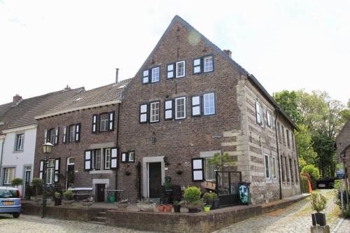 a large brick building with windows on a street at Authentic Stays - 6p-maisonette in Eijsden