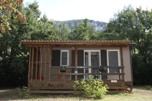 a tiny house in the middle of the forest at Camping du lac in Saint-Julien-du-Verdon