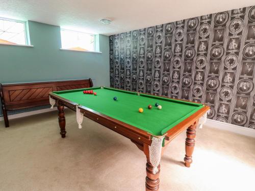 a pool table with balls on it in a room at Manor House in Accrington
