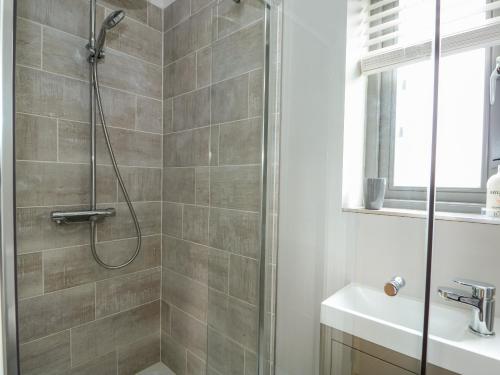 a bathroom with a shower and a sink at The Stables in Boston