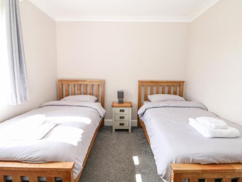 a room with two twin beds and a night stand at The Stables in Boston