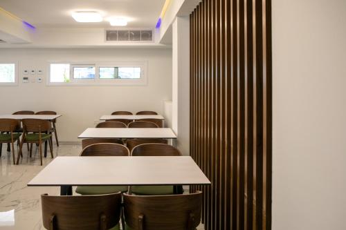 a row of tables and chairs in a room at Best Western Plus Larco Hotel in Larnaka