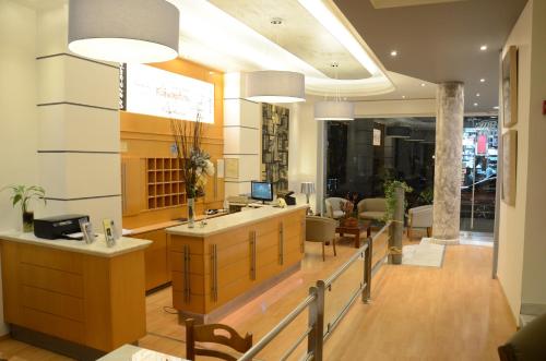 a lobby with a reception desk and a living room at Marie Palace in Patra