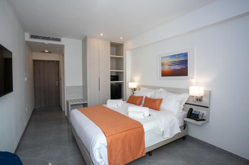 a bedroom with a large bed and a television at Best Western Plus Larco Hotel in Larnaka