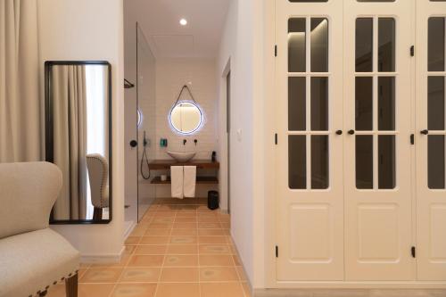 a bathroom with a sink and a mirror at Albariza Hotel Boutique in Sanlúcar de Barrameda