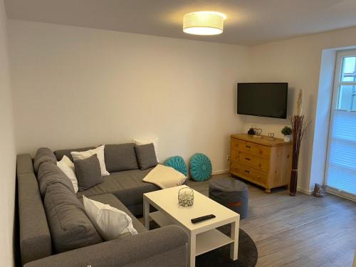 a living room with a couch and a tv at Ferienwohnung Wülfrath in Wülfrath