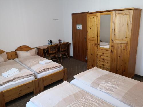 a bedroom with two beds and a desk with a table at Pension am Heusteig in Stuttgart