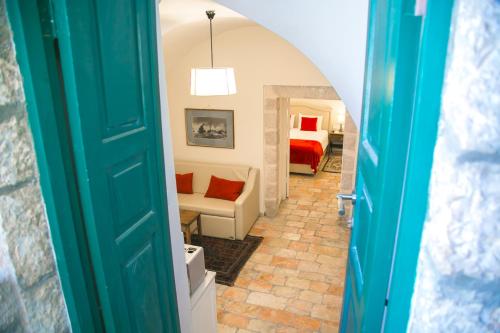 a hallway with a room with a bed and a couch at The Templer Inn in Jerusalem
