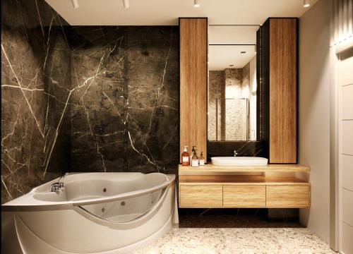 a bathroom with a tub and a sink at Privilege Suites by Central Park in Belgrade