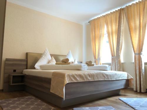 a bedroom with a bed with two teddy bears on it at Pension Goldenes Vogtland in Adorf