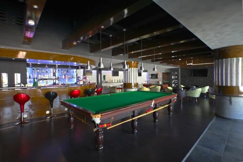 a pool table in a room with a bar at Hotel Muscat Holiday in Muscat
