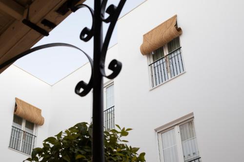 a street light with two windows and a building at Albariza Hotel Boutique in Sanlúcar de Barrameda