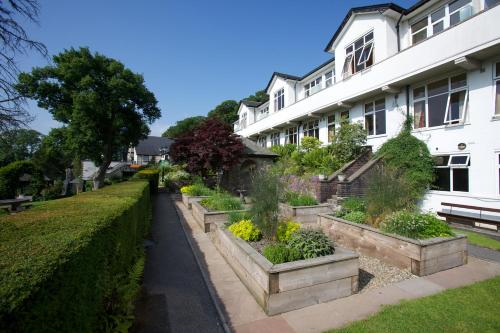 a row of potted plants in front of a building at Castle Green Hotel In Kendal, BW Premier Collection in Kendal