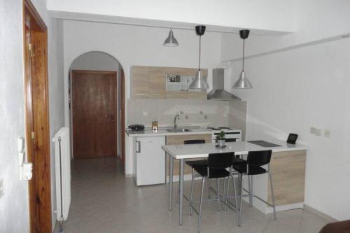 a kitchen with a table and chairs in it at Baou House in Metsovo