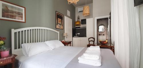 a bedroom with a white bed with towels on it at Muziqa Apartments in Dubrovnik