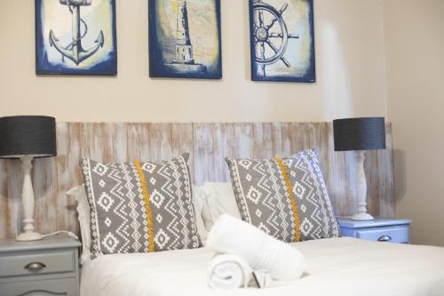 a bedroom with a bed with pillows and two lamps at iLanga Lodge in St Lucia