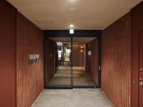 a hallway of a building with a hallwayngth at THE KNOT SAPPORO in Sapporo