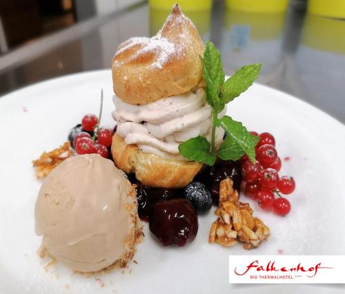 a plate of food with a pastry and ice cream at Bio Thermalhotel Falkenhof in Bad Füssing