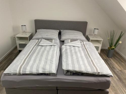 a bed with two pillows on it in a room at Apartments Benzweg 2 in Northeim