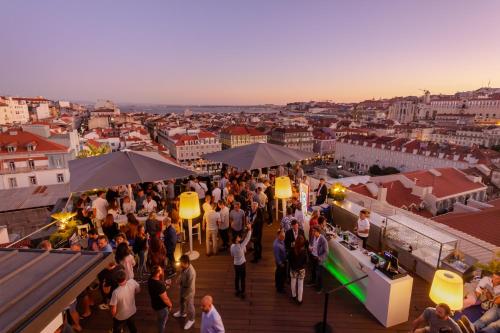 a crowd of people standing on a deck looking over a city at Hotel Mundial in Lisbon