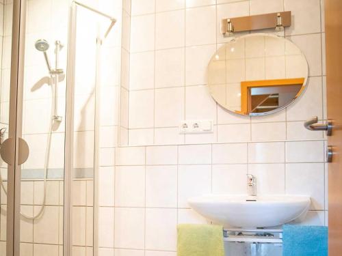 a bathroom with a sink and a mirror at Ennerla Hof in Pottenstein