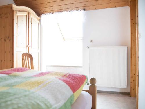 a bedroom with a bed and a window at Ennerla Hof in Pottenstein