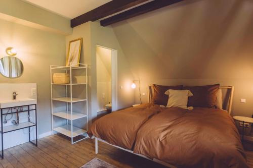 a bedroom with a bed and a book shelf at EDELFUCHS-LODGE in Bühlertal
