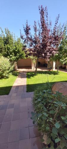 a walkway in a park with trees and grass at Casa del Portalón in Ituero y Lama