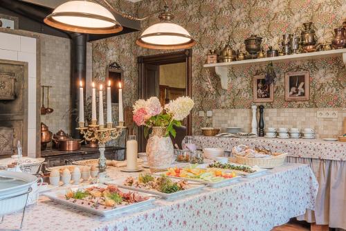a buffet of food on a table in a kitchen at Liepupe Manor in Liepupe