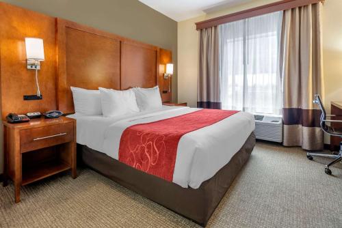 a hotel room with a large bed and a window at Comfort Suites Newark - Harrison in Newark