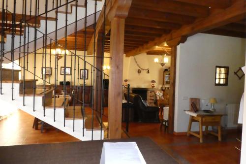 a living room with a staircase in a house at Casa del Portalón in Ituero y Lama