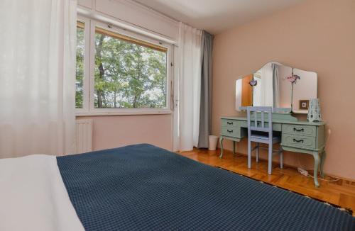 a bedroom with a bed and a dresser and a mirror at Old Chestnut Vacation Home in Varaždinske Toplice