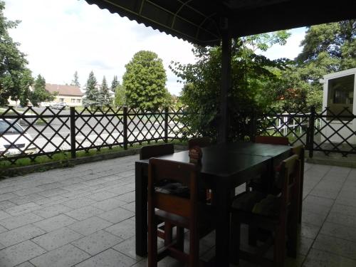 a table and chairs under an umbrella on a patio at Penzion Krásný Dvůr in Krásný Dvŭr