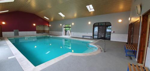 a large swimming pool in a building at LLety Cynin in Llangynin