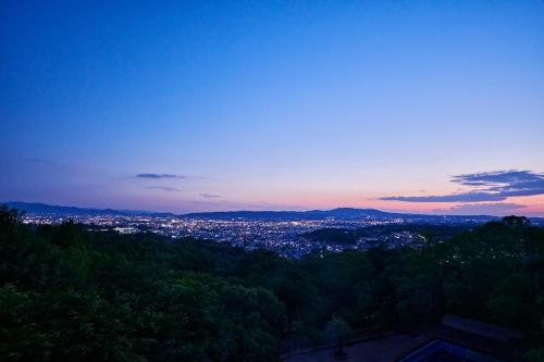 a view of a city at dusk at ANDO HOTEL NARA Wakakusayama -DLIGHT LIFE & HOTELS- in Nara