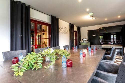 a long table with chairs and bottles of water on it at Auberge De Maison Rouge in Vétraz-Monthoux