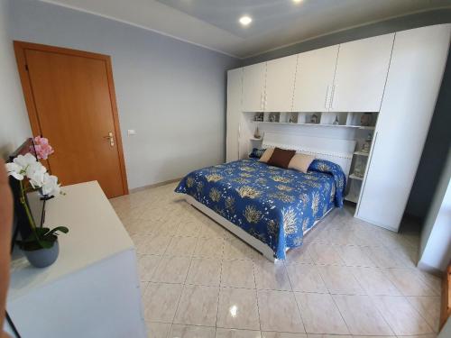 a bedroom with a bed with a blue comforter at NEW PANORAMA in Riposto