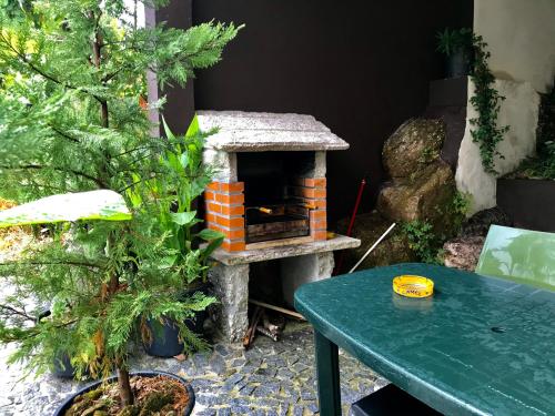a patio with a pizza oven and a table at Casa de Casarelhos - "Gerês" - Estúdio piso 0 - Apartamento Piso 1 in Geres